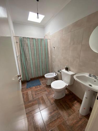 a bathroom with a sink and a toilet and a shower at El Despertar in Concepción del Uruguay