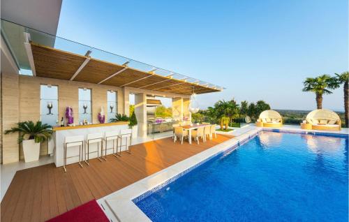 a house with a swimming pool with a kitchen and a bar at Villa Petra Pag in Borovići