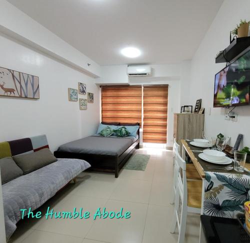 a living room with a couch and a table at The Humble Abode in Tagaytay