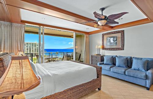 a bedroom with a bed and a couch at The Whaler By Maui Resort Rentals in Lahaina
