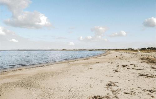 a sandy beach with water and clouds in the sky at 3 Bedroom Gorgeous Home In Knebel in Knebel