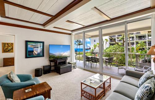 a living room with a couch and a table at The Whaler By Maui Resort Rentals in Lahaina
