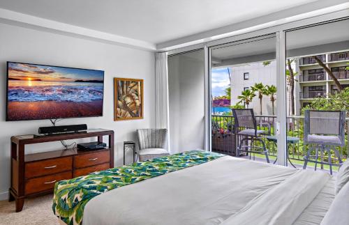 a bedroom with a bed and a large window at The Whaler By Maui Resort Rentals in Lahaina