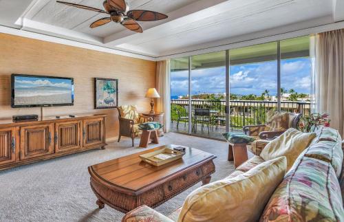 a living room with a couch and a tv at The Whaler By Maui Resort Rentals in Lahaina