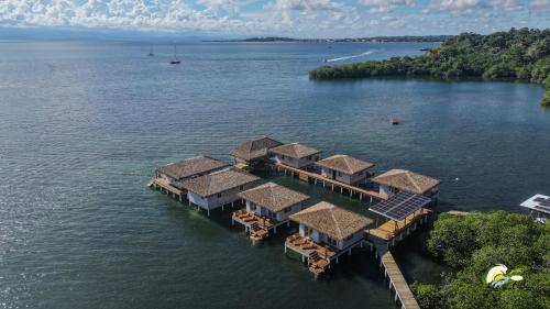 an aerial view of a house in the water at CoralBay Bungalows Solarte in Solarte