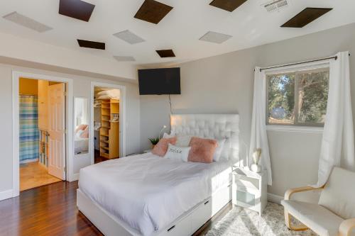 a bedroom with a white bed and a window at Scenic Mancos Hideaway Less Than 2 Mi to Mesa Verde! in Mancos
