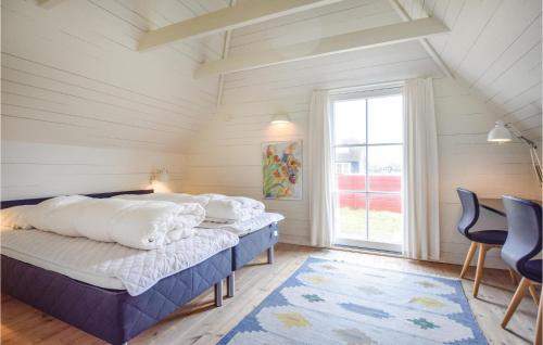 a bedroom with two beds and a large window at Amazing Home In Blåvand With Wifi in Blåvand