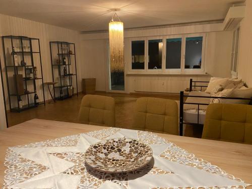 a dining room with a table with a plate on it at Im grünen aber in 20min in Basel in Ettingen