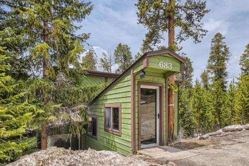 a green tiny house in the woods at Gasthaus Breck home in Breckenridge