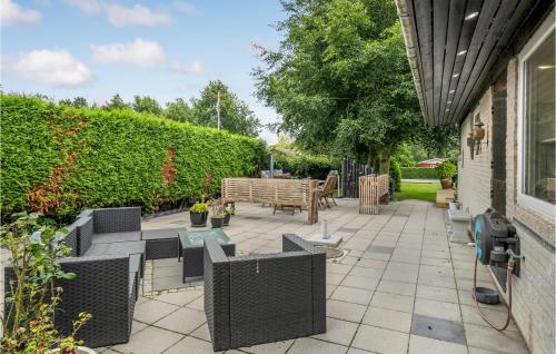 a patio with chairs and a table and a bench at Lovely Home In Gørlev With Kitchen in Gørlev