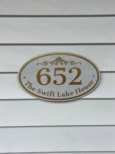 a sign on the side of a white house at The Swift Lake House in Somerset