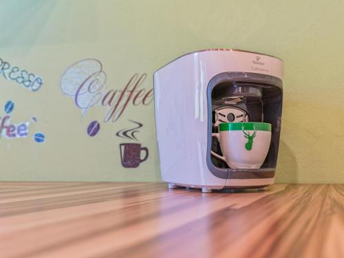 a toaster sitting on a wooden floor next to a wall at Sonja in Scheffach