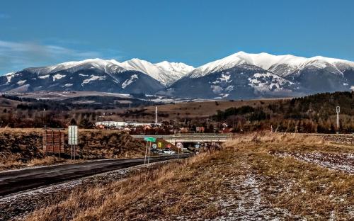 a mountain range with snow covered mountains in the distance at Apartmán " Matej" in Smrečany