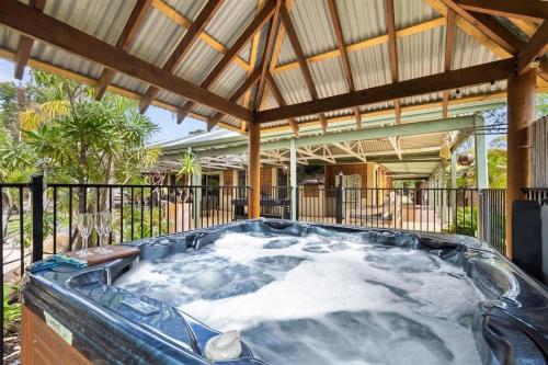 a hot tub in the backyard of a house at Dandjoo - hot tub, fire pit, outdoor entertainment in Dunsborough