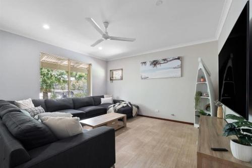a living room with a couch and a table at Dandjoo - hot tub, fire pit, outdoor entertainment in Dunsborough