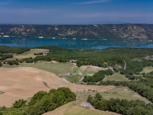 an aerial view of a golf course next to the water at Verdon in Aiguines