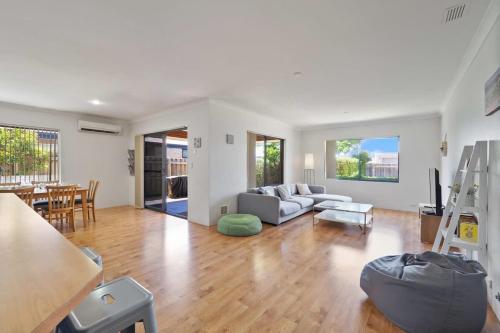 a living room with a couch and a table at Across the Way, golf and beach heaven in Dunsborough