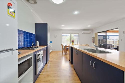 a kitchen with a sink and a counter top at Across the Way, golf and beach heaven in Dunsborough