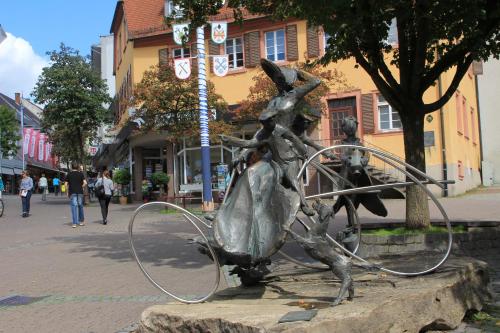 a metal statue of a woman with a hoop at Hotel Ifen in Wiesloch