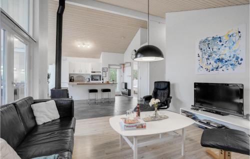 a living room with a couch and a table at Holiday Home Kronvildtvej Brovst I in Brovst