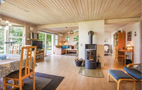 a living room with a wood stove in the middle at Lillebo in Brejning