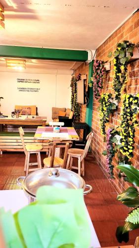 a restaurant with tables and chairs and a brick wall at Oporto 83 in Bogotá