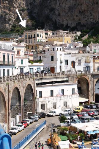 a city with cars parked in a parking lot at Lae Domus in Atrani