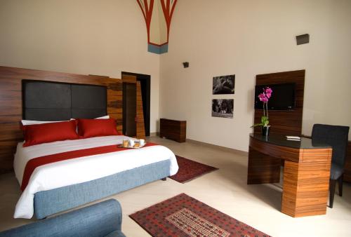 ein Schlafzimmer mit einem großen Bett und einem Schreibtisch sowie einem Bett von sidx sidx sidx sidx sidx in der Unterkunft Alvino Suite And Breakfast in Lecce