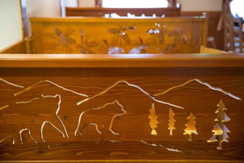 a wooden altar with a drawing of a mountain at Hotel Knez in Kupres