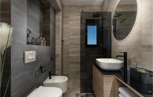 a bathroom with a white toilet and a sink at Villa Quercus in Briševo