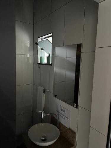 a bathroom with a sink and a mirror at Casa Almeida in Tiradentes