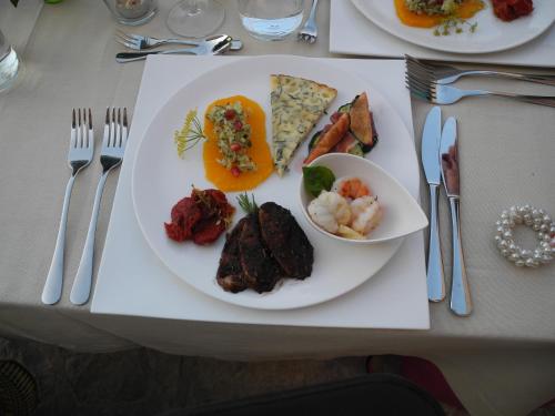a white plate of food on a table with silverware at Agroturismo S Hort de Can Carrio AG226 in Ses Salines