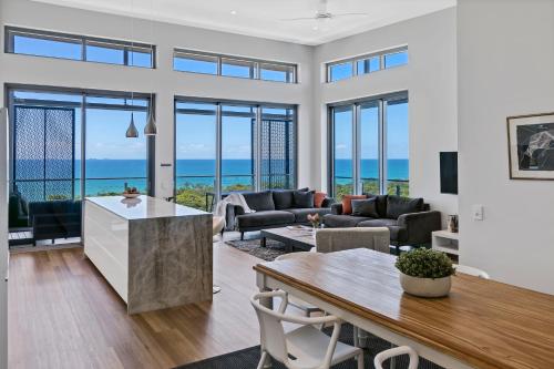 a living room with a view of the ocean at Bokarina Beach Apartments, an Ascend Collection Hotel in Bokarina