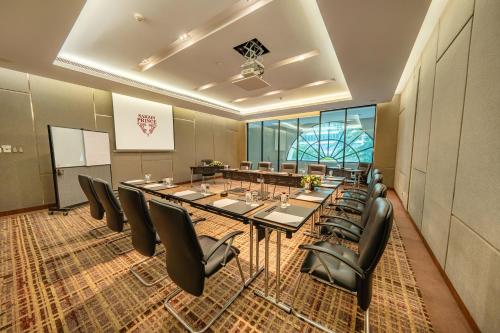 a conference room with a long table and chairs at Saigon Prince Hotel in Ho Chi Minh City