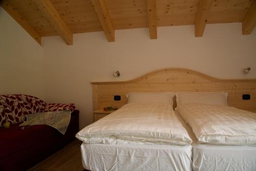 a bedroom with two beds with white sheets at Abete Rosso in Rabbi