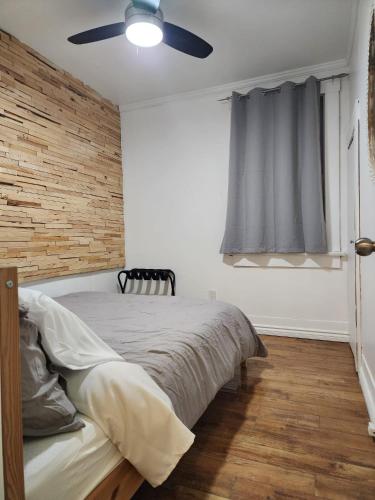 a bedroom with a bed and a ceiling fan at 2-bed house for downtown, stampede & mountains in Calgary