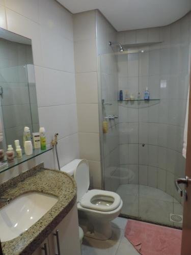 a bathroom with a shower and a toilet and a sink at Scopa Beach Resort Cavalcanti in Aquiraz