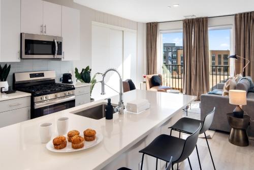 a kitchen and living room with a white counter top at Luxury Furnished Apartments by Hyatus Downtown at Yale in New Haven