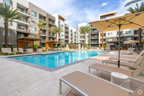 a swimming pool with chairs and a hotel at Spacious Resort style 2Bedroom 2Bath Oasis Pool Gym Desert Ridge in Phoenix