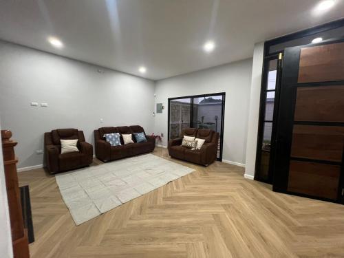 a living room with two couches and a rug at La Isla Bonita Residence in Flores