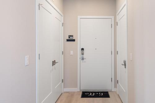 a hallway with white walls and a door at Luxury Furnished Apartments by Hyatus Downtown at Yale in New Haven