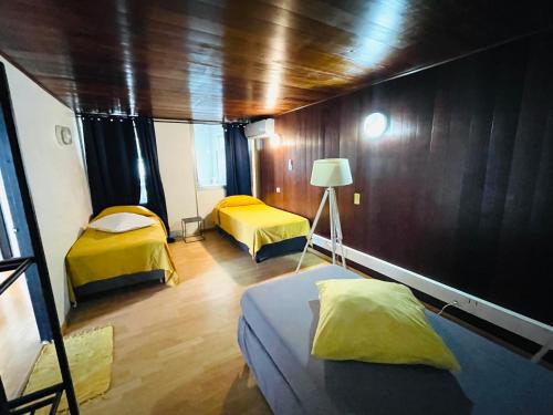 a room with two beds and a lamp in it at Penthouse Happiness in Papeete
