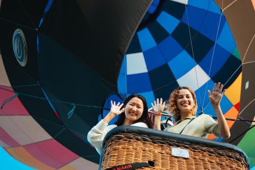 two women are riding in a hot air balloon at Solabase in Kazo