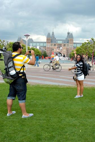 two people standing in the grass taking a picture at Stayokay Hostel Amsterdam Vondelpark in Amsterdam