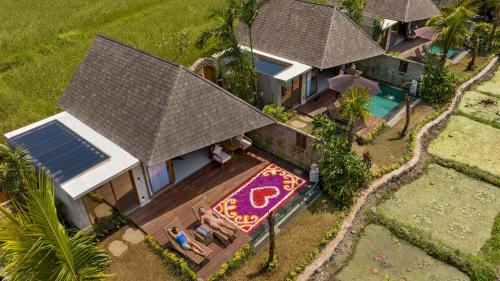 an overhead view of a house with a swimming pool at Lasamana Villas Ubud by GenuineHost in Ubud