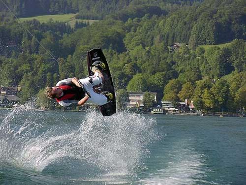 a person on a snowboard jumping in the water at Reiterhof Suassbauer in St. Wolfgang