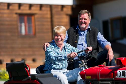 a man and an older woman sitting on a motorcycle at Reiterhof Suassbauer in St. Wolfgang