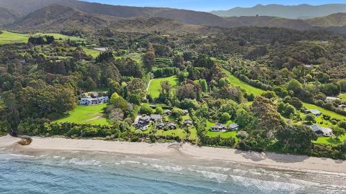an aerial view of a house on a beach at Adrift In Golden Bay- Absolute Beachfront Villas in Collingwood