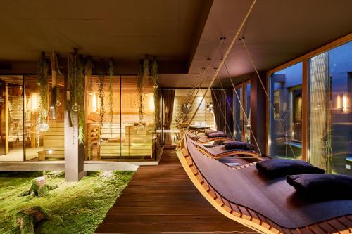 a room with a large bed hanging from the ceiling at Lifestyle Hotel eder in Maria Alm am Steinernen Meer