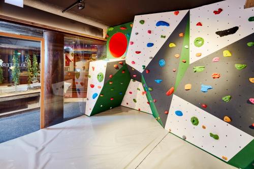 a room with a climbing wall in a store at Lifestyle Hotel eder in Maria Alm am Steinernen Meer